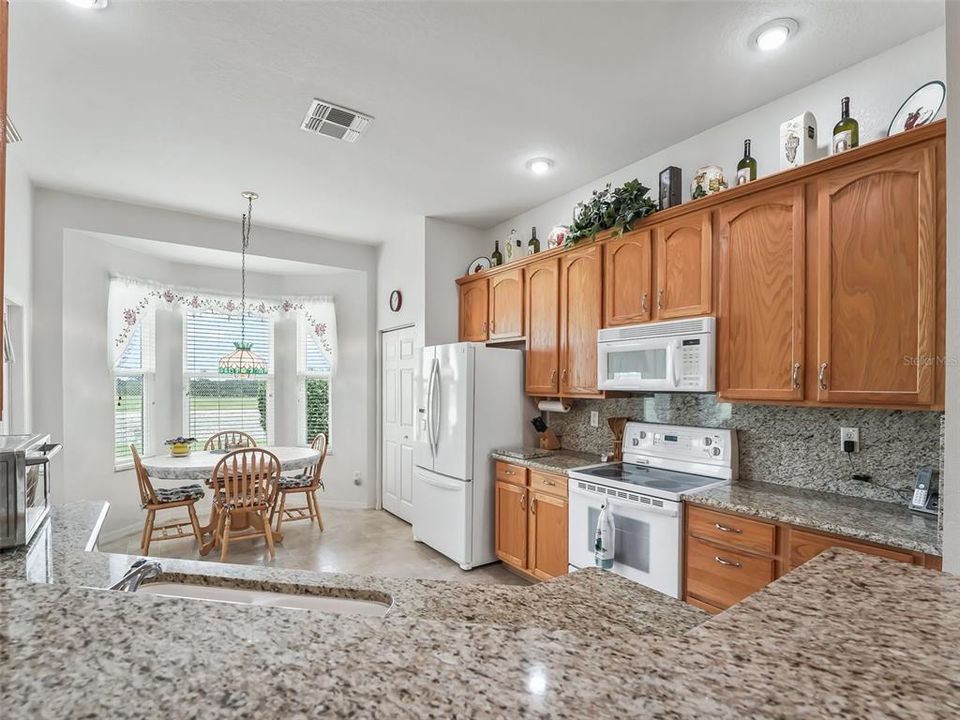 Large eat in Kitchen w/Pantry & wood cabinets