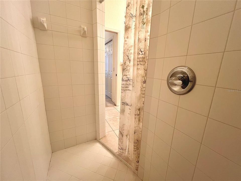 nicely tiled shower in master bathroom