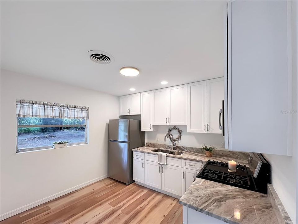 Updated Kitchen featuring new 42" White ShakerCabinets, Granite Countertops, Stainless Steel Appliances, LVP Flooring, Paint and Recessed Lighting