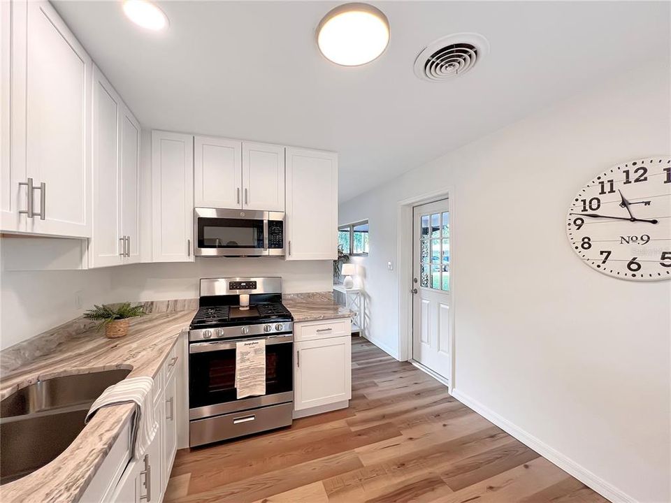 Updated Kitchen featuring new 42" White ShakerCabinets, Granite Countertops, Stainless Steel Appliances, LVP Flooring, Paint and Recessed Lighting