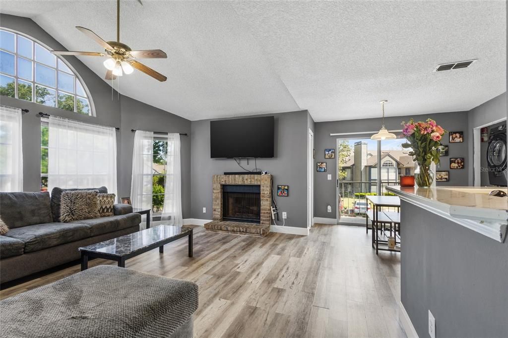 Cozy living room.  Laminate floors, wood burning fireplace, LOTS of light