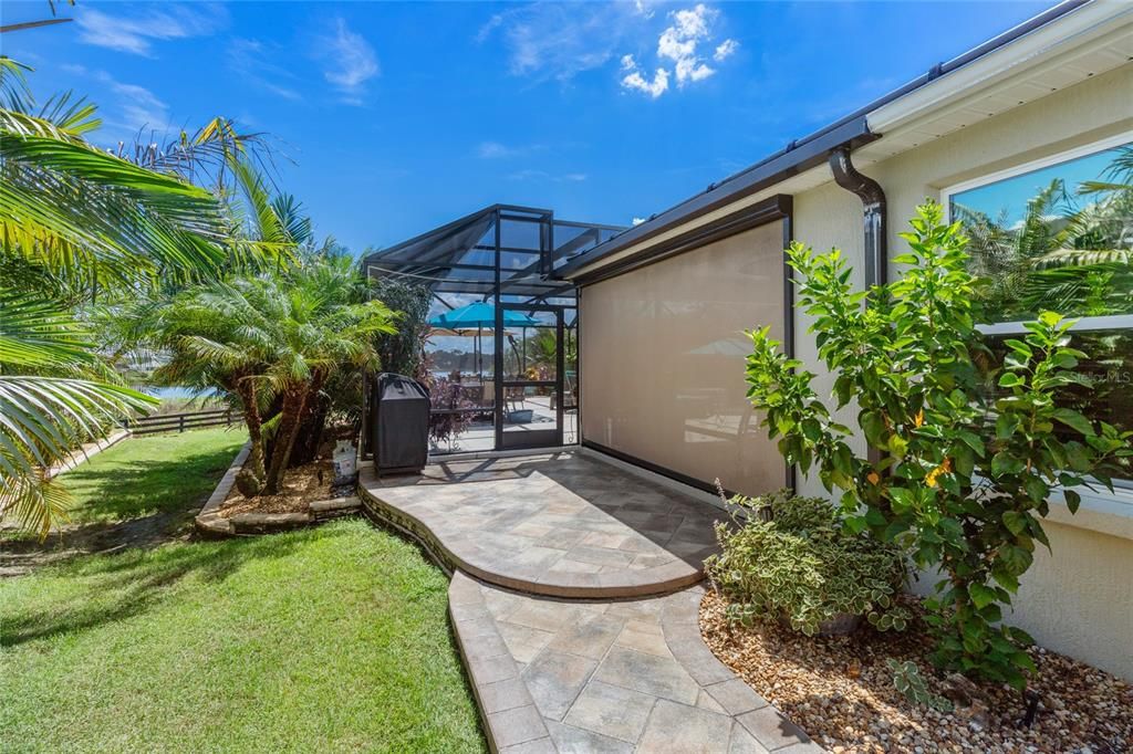 Paver Walkway on the side of the home leading to glorious outdoor entertaining area