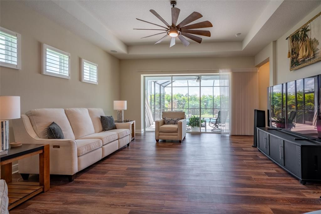 TRIPLE SLIDING GLASS DOORS LEAD OUT TO POOL/COVERED LANAI.