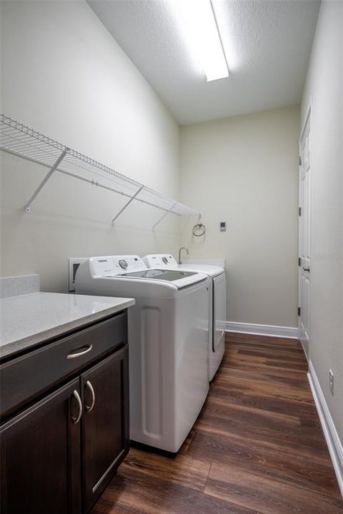 LAUNDRY ROOM HAS CABINET & UTILITY SINK.