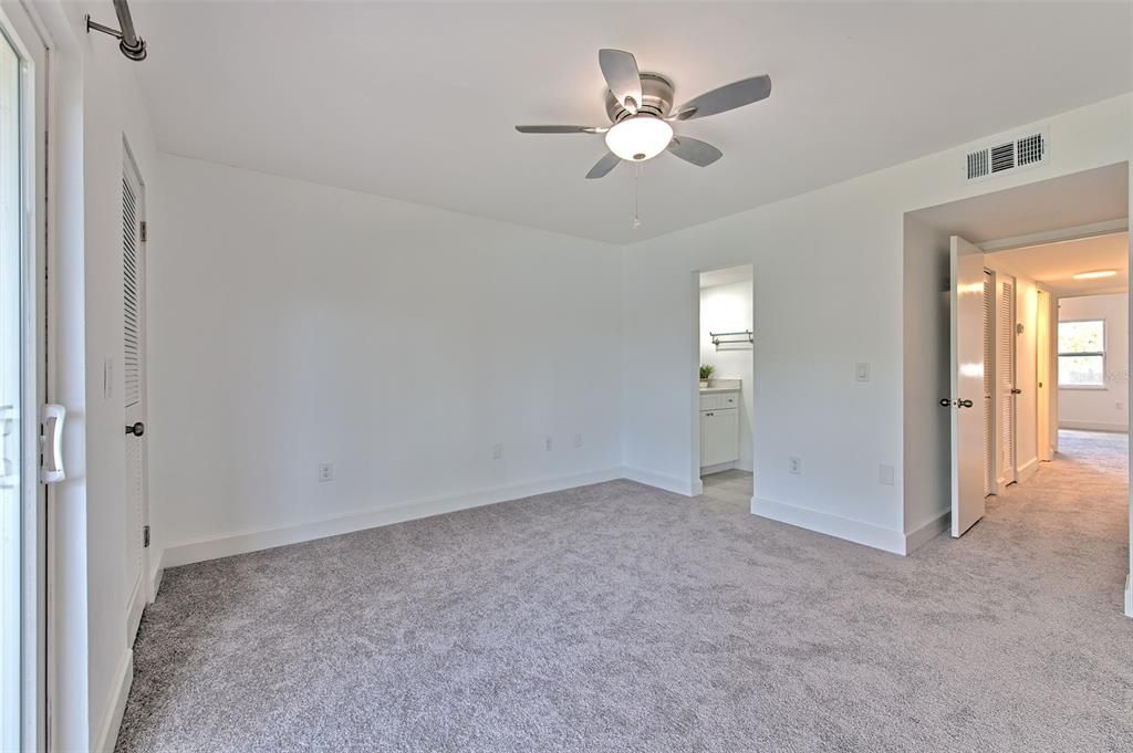 Upstairs primary bedroom with balcony