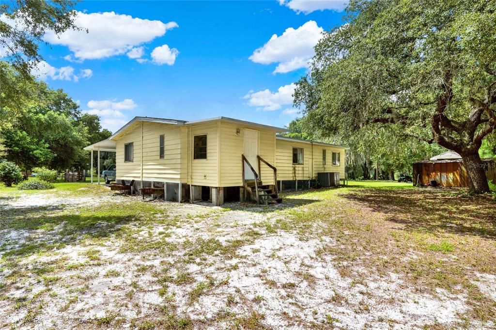 Property has a shed - Second Manufactured home is in the distance behind the tree.