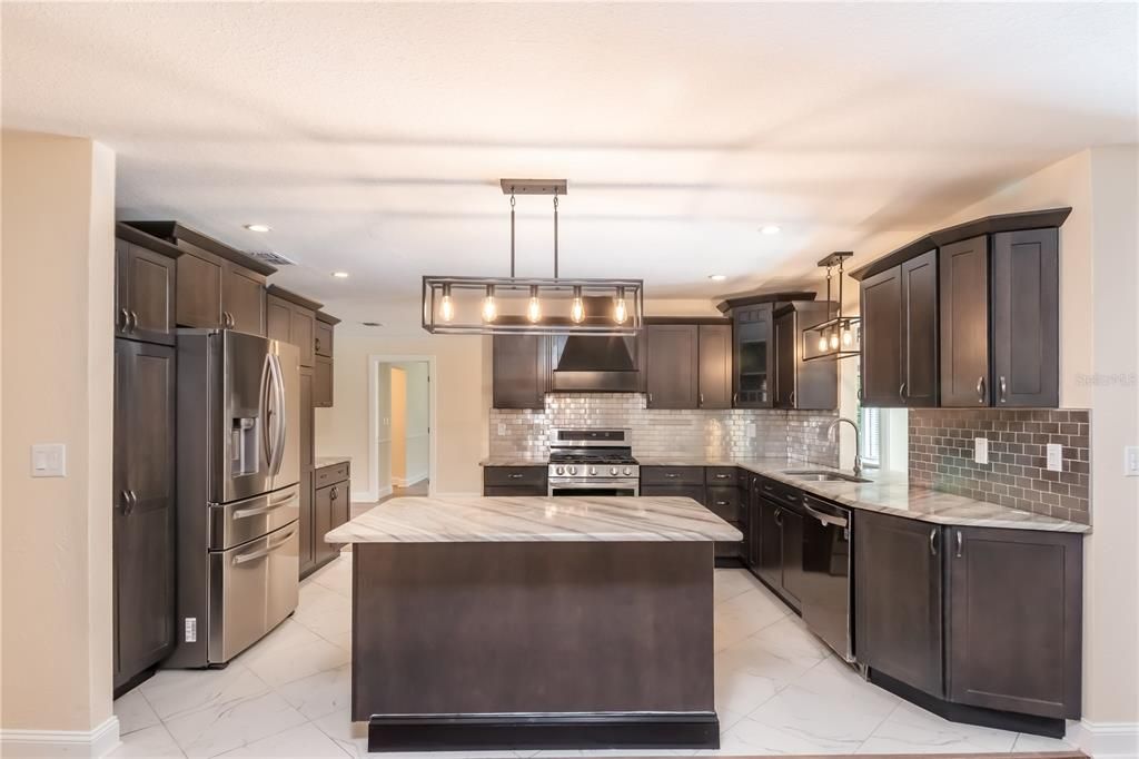 Stainless appliances and propane stove in a well laid out kitchen