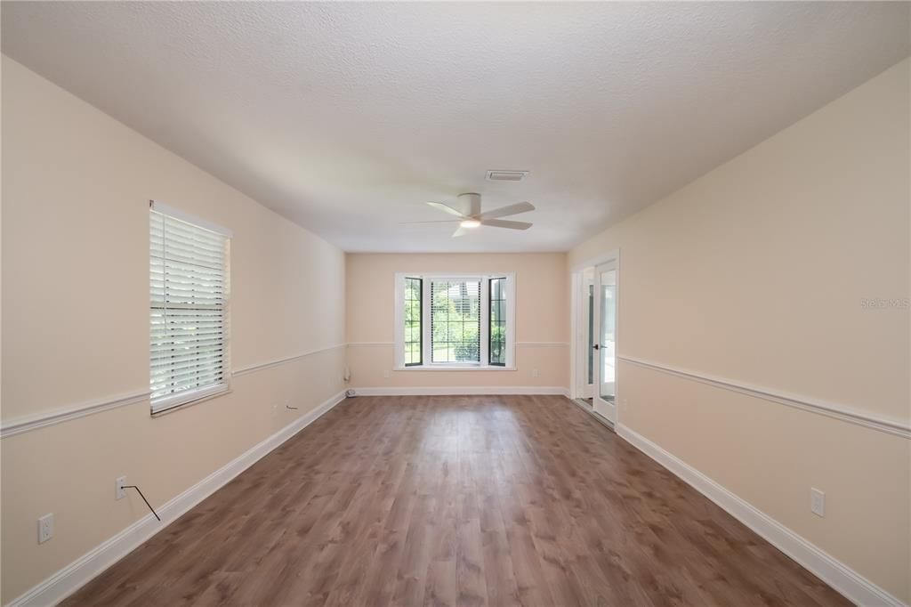 Primary bedroom with beautiful bowed window looking at the back yard