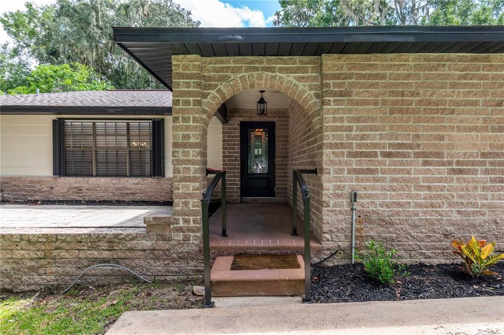 Charming covered entry with a spacious terrace