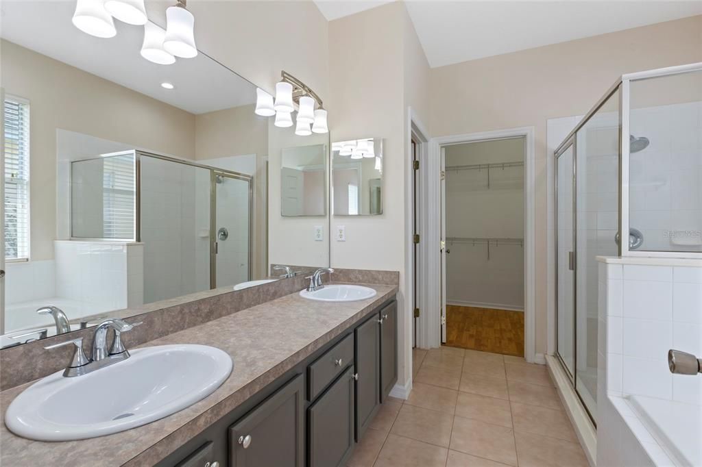 Master bath with brand new sinks and fixtures, great garden bath tub, shower and large walk in closet.