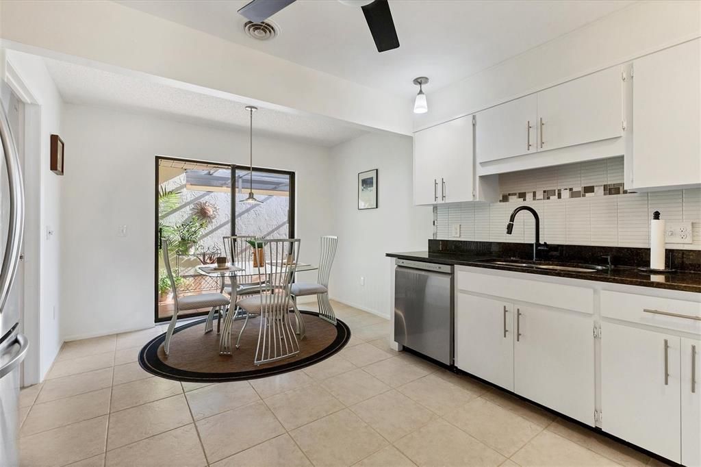 eat-in kitchen with sliders to screened courtyard & gas grill