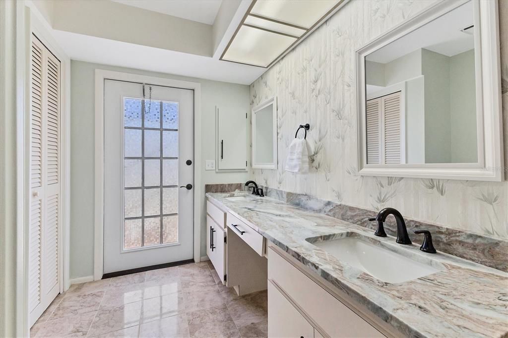 granite countertops with french door leading out to screened courtyard