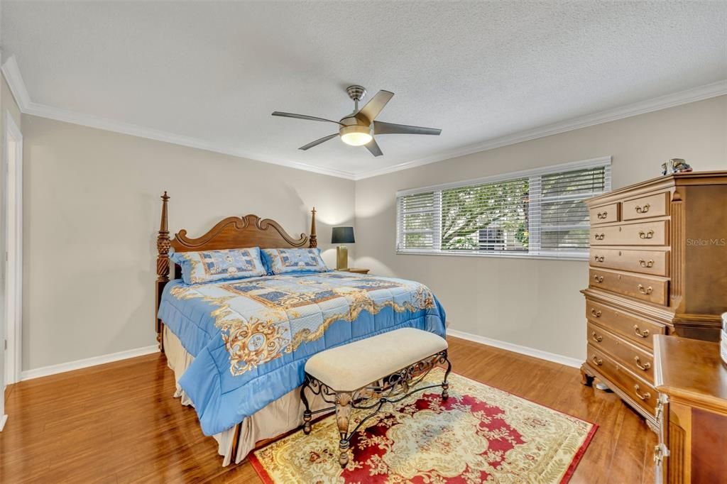 Primary bedroom overlooking gardens and pool