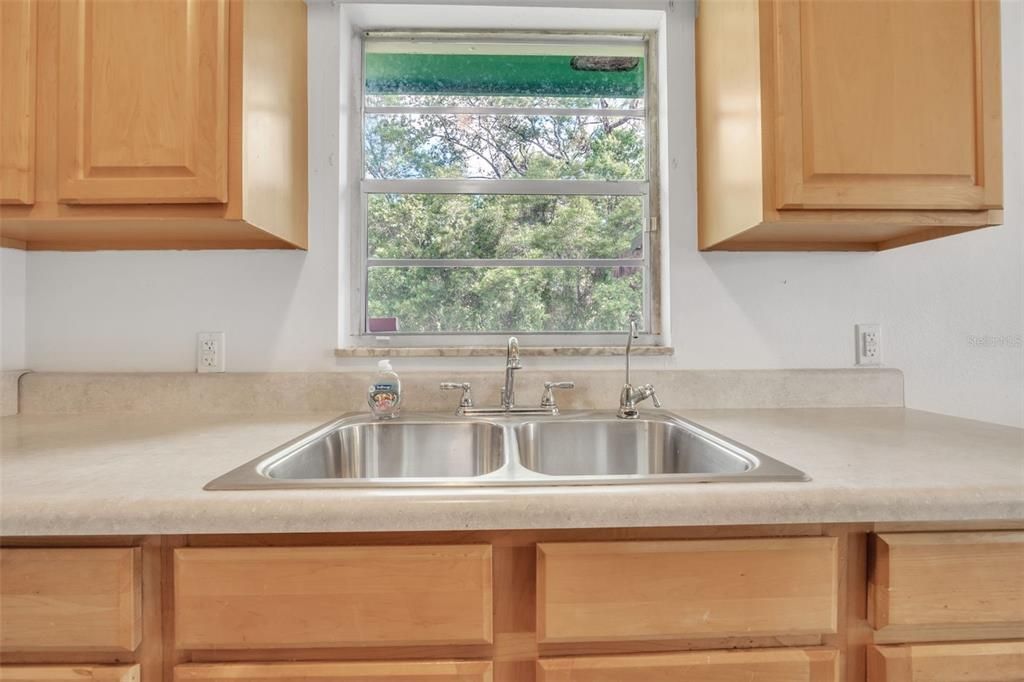 Kitchen window has view of your private backyard.