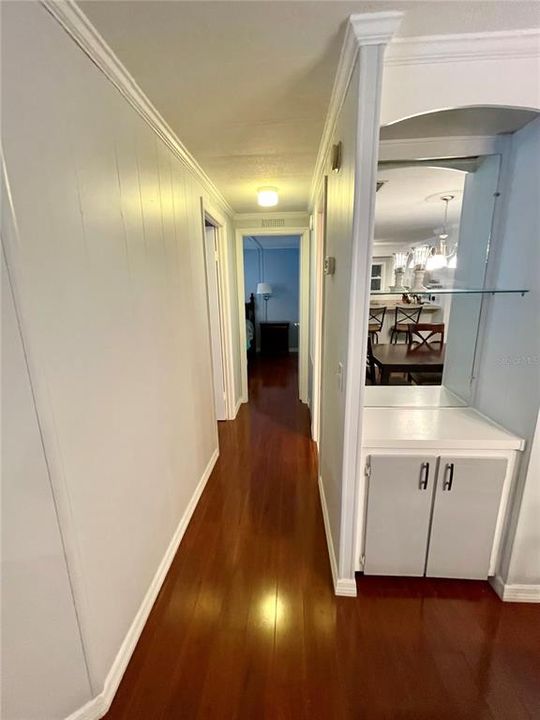 Down the hall, hall bath to the right, guest bedroom across from the bathroom... and the primary bedroom is straight ahead which encompasses the back section of the home.