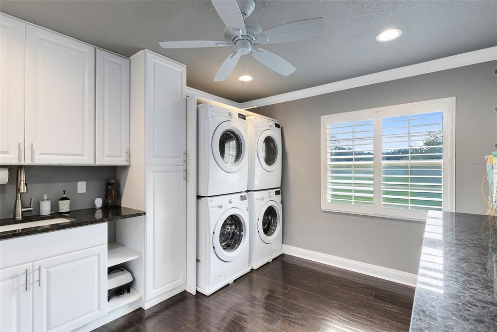 Laundry room with double washers and dryers. tons of additional counter space, another refridgereator and