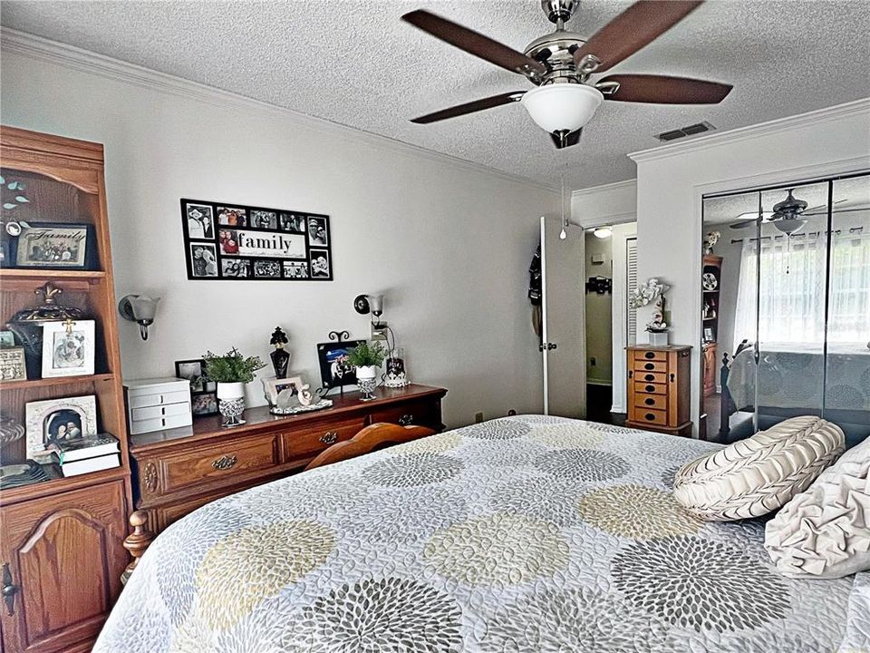 Primary bedroom w closets, ceiling fan