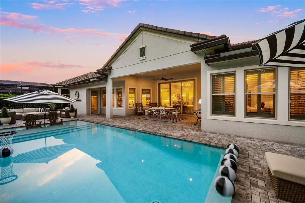 Family and informal eating overlook the pool