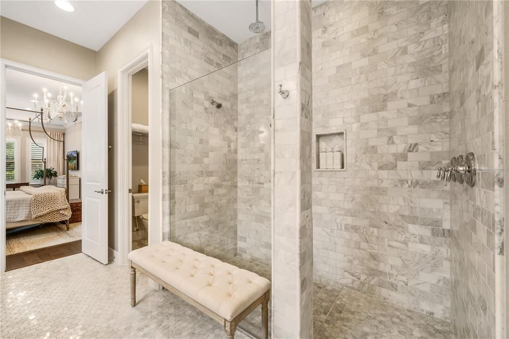 Extra large walk-in shower with marble subway tile, three separate shower heads & individual controls