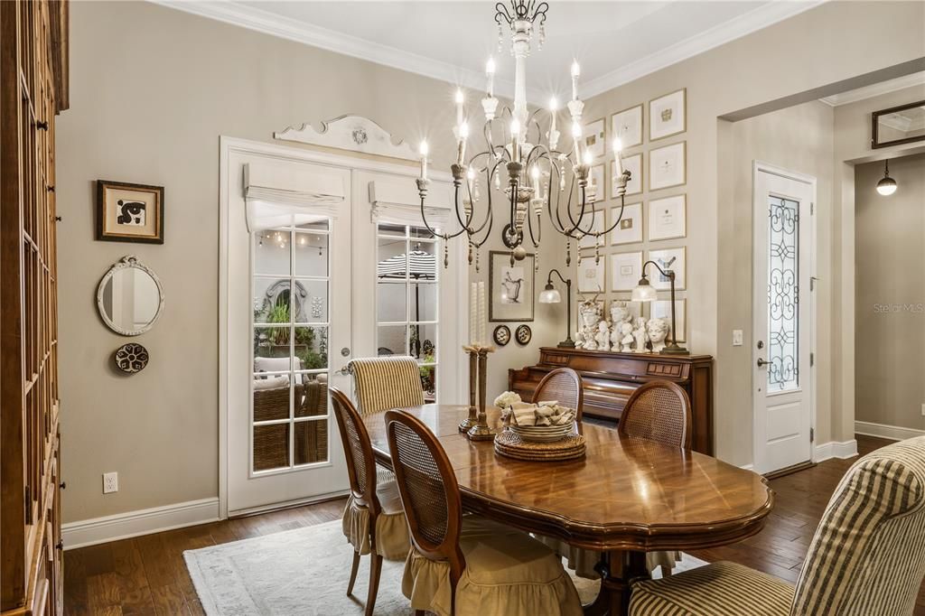 Spacious dining area off the foyer has crown molding and high ceilings.