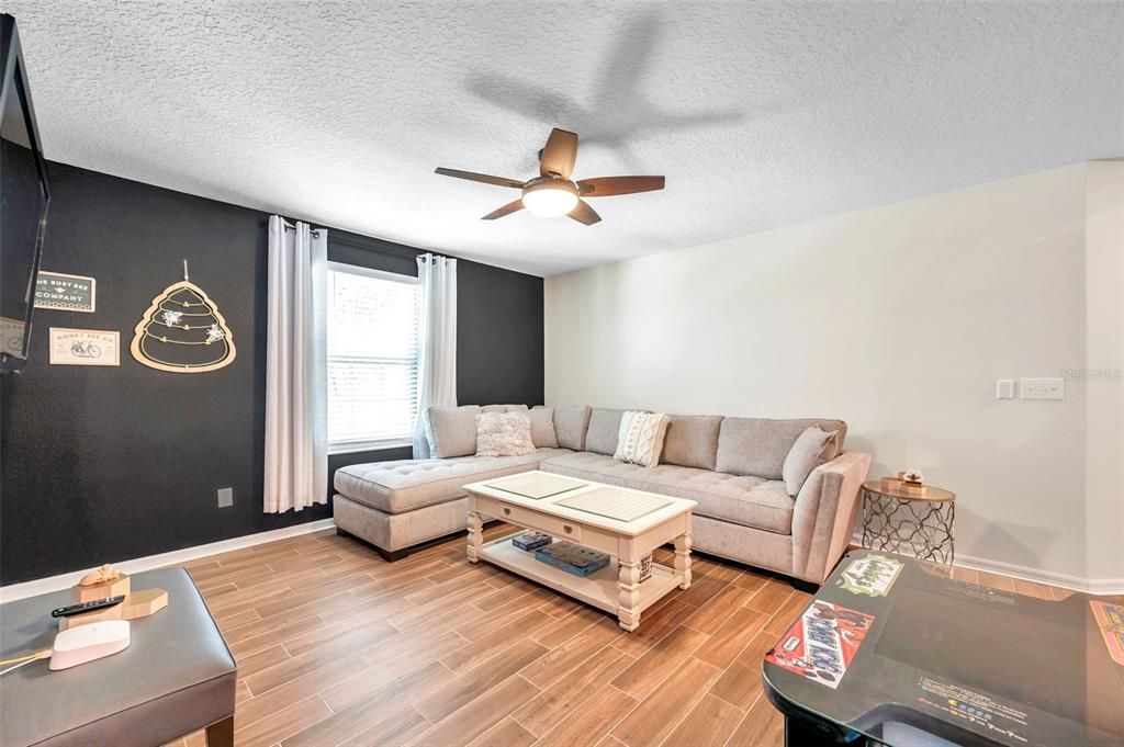 Upstairs bonus room with lunge, sofa and game room