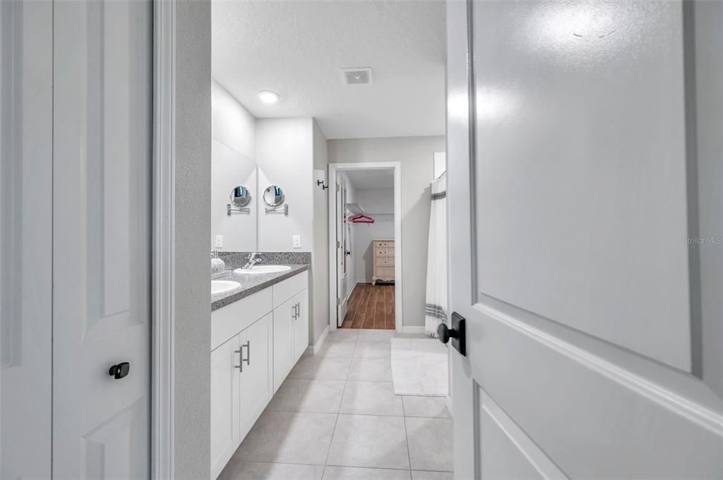 Master bathroom with large walk-in closet