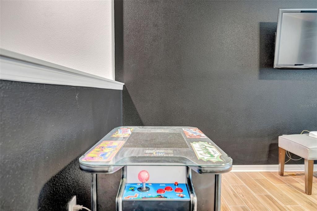 Upstairs bonus room with lunge, sofa and game room