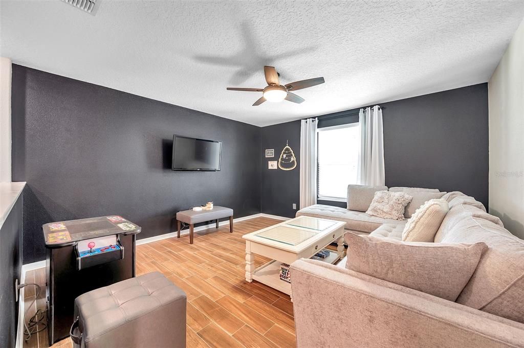 Upstairs bonus room with lunge, sofa and game room