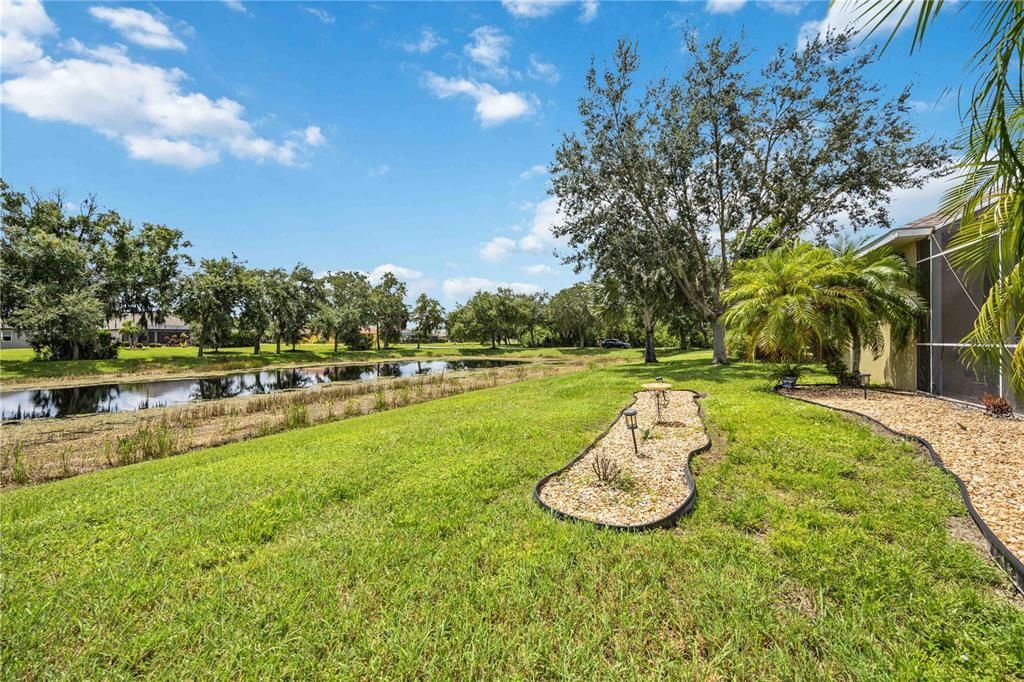 Step right outside from your backdoor in the enclosed lanai to lush landscaping and lake views