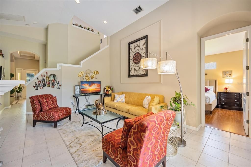 Tile flooring flows through this home with designer pebble mosaic stone, high vaulted, cathedral ceiling and an luxurious natural gas fireplace.