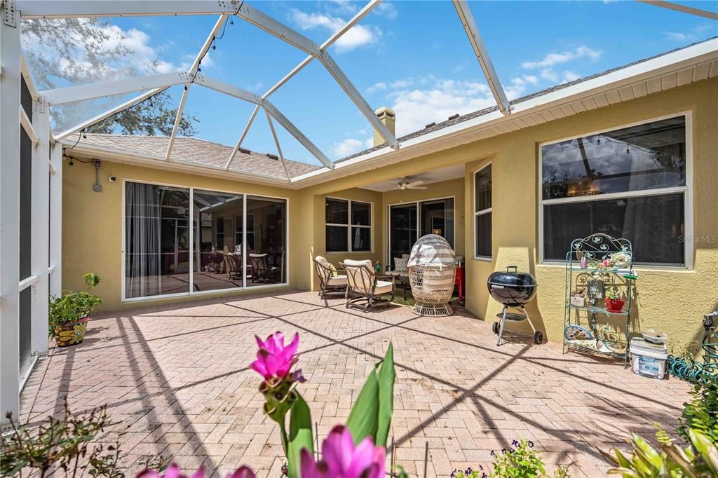 Tropical paradise outdoor lanai space has 3 separate entry points leading inside the home