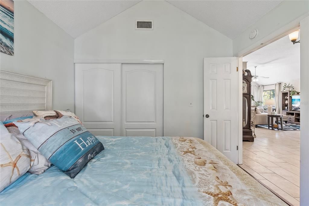 Guest bedroom with living room in the background