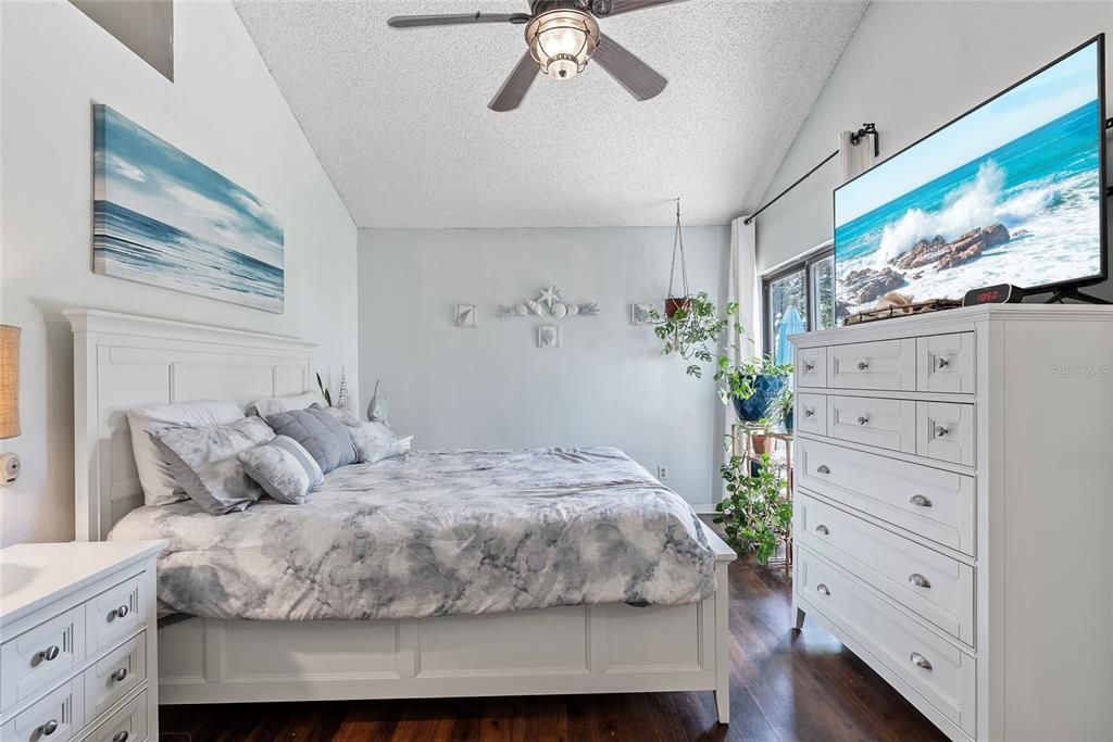 Alternate view of primary bedroom.  Sliding glass doors next to the dresser lead to the back patio and back yard.