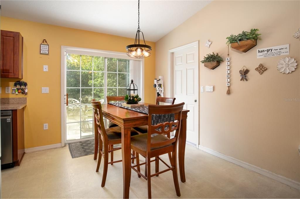 Dining area with glass doors onto patio and garage access.