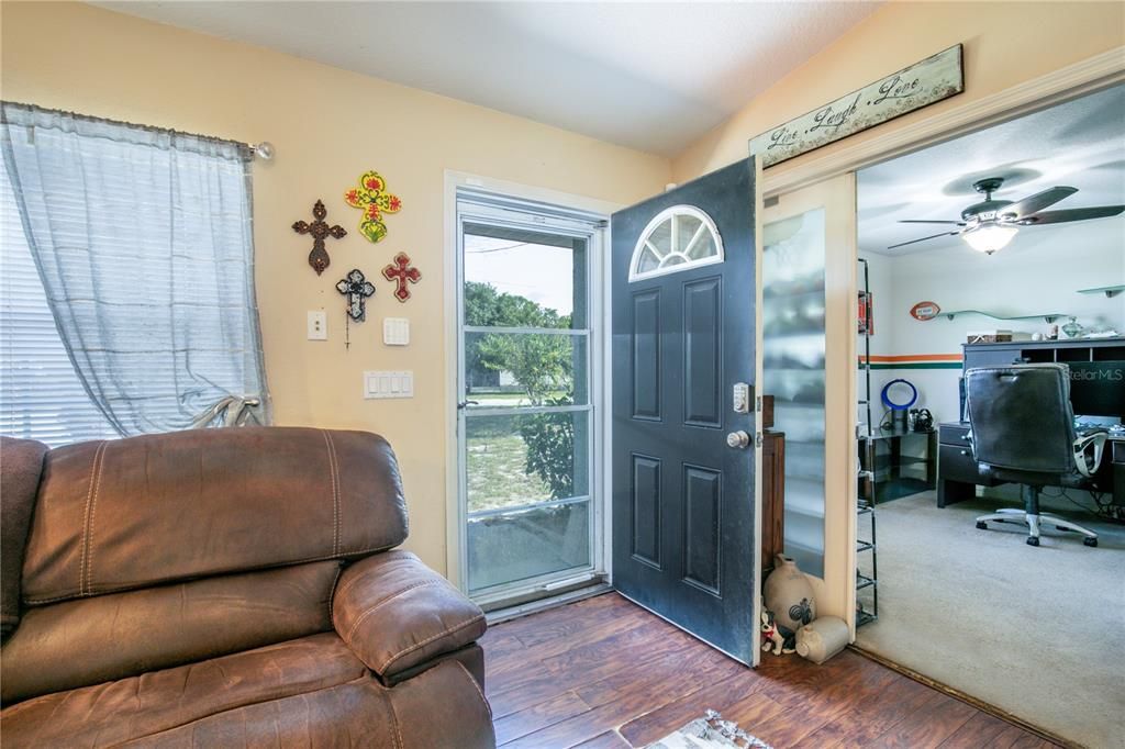 Living room looking into den/study and out front door.