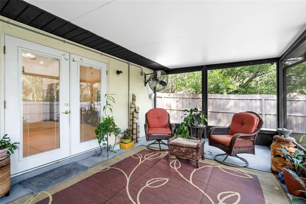 French doors off the living area open up to a large SCREENED LANAI and the FENCED BACKYARD beyond for indoor/outdoor living and entertaining friends and family with ease.