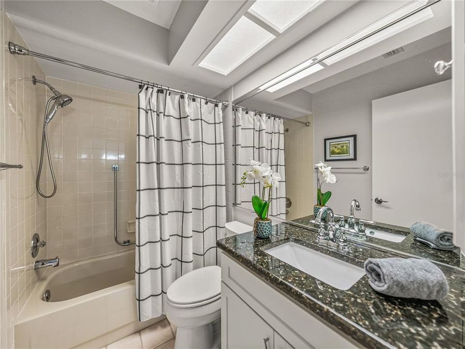 Updated hall bath with granite countertops, newer vanity, and tub/shower combo~