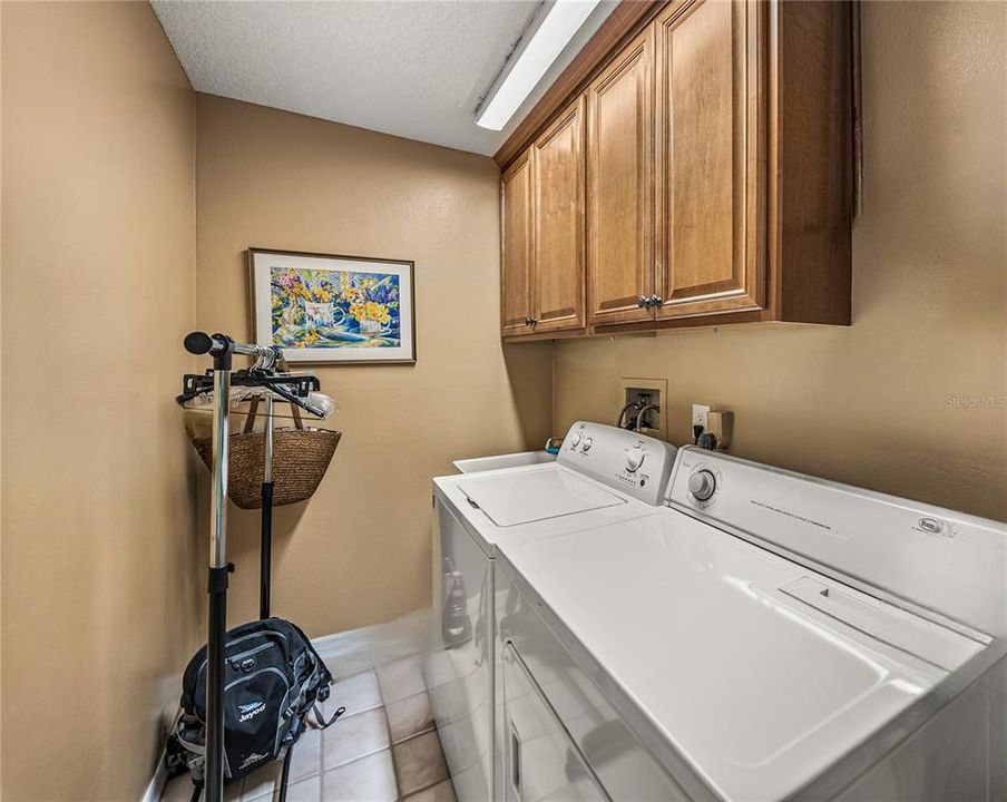 Laundry room with extra storage and convenient utility sink~