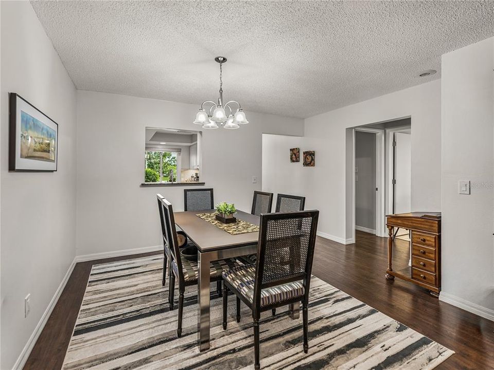 Dining area open to kitchen & hallway to guest suite, updated hall bath, and laundry room~