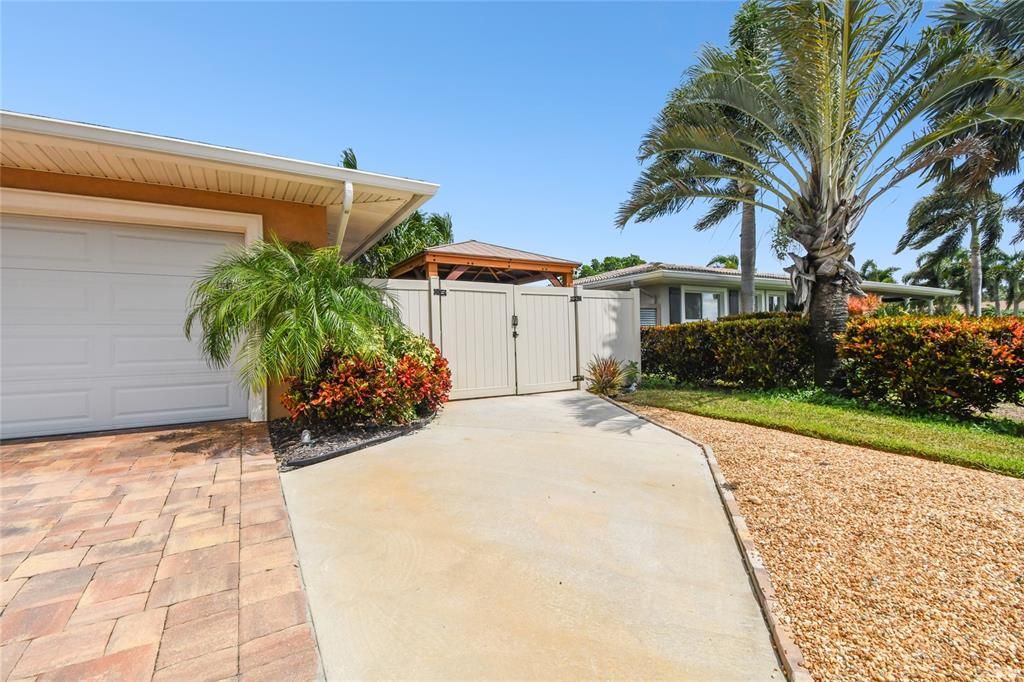 Extra parking pad and double gate to backyard