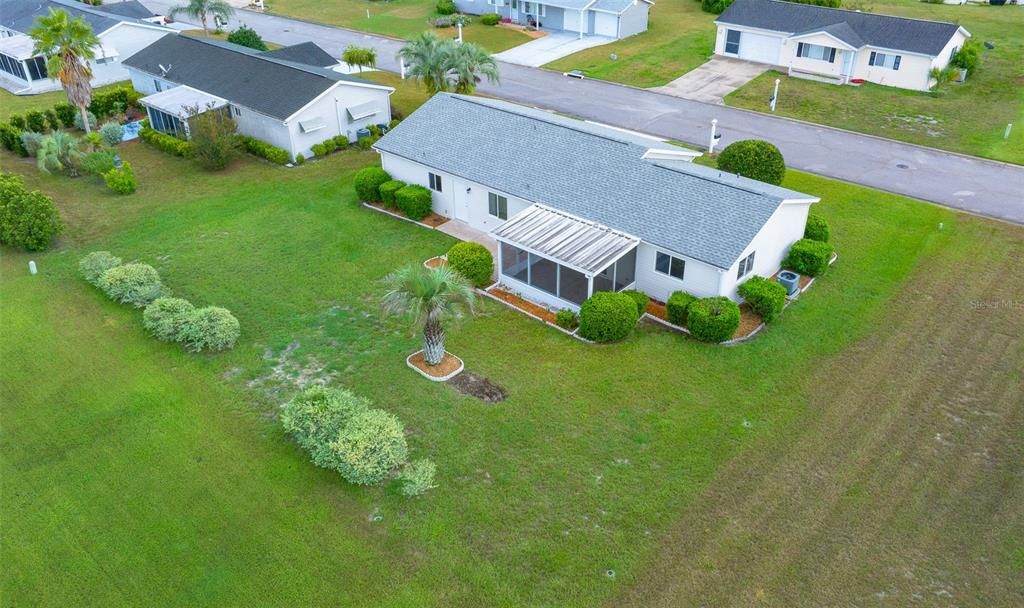 Nicely mulched around trees and bushes. Back screened in Fla Room