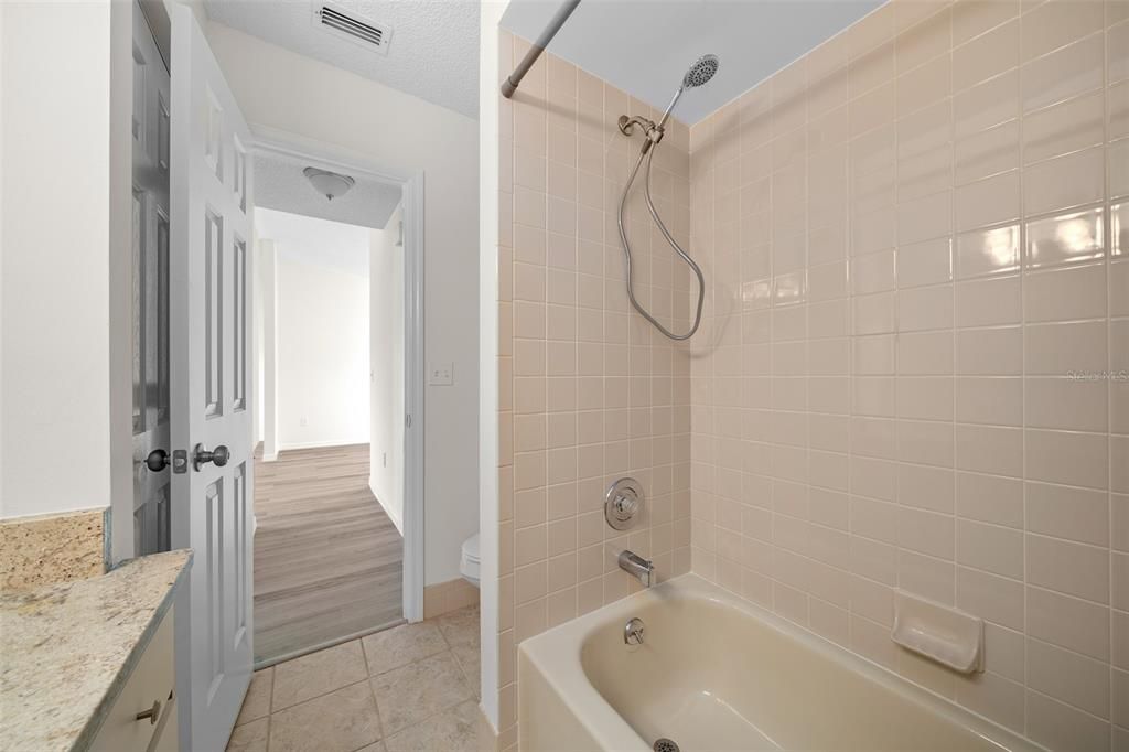 Guest bath has new shower head, new toilet and a spacious linen closet