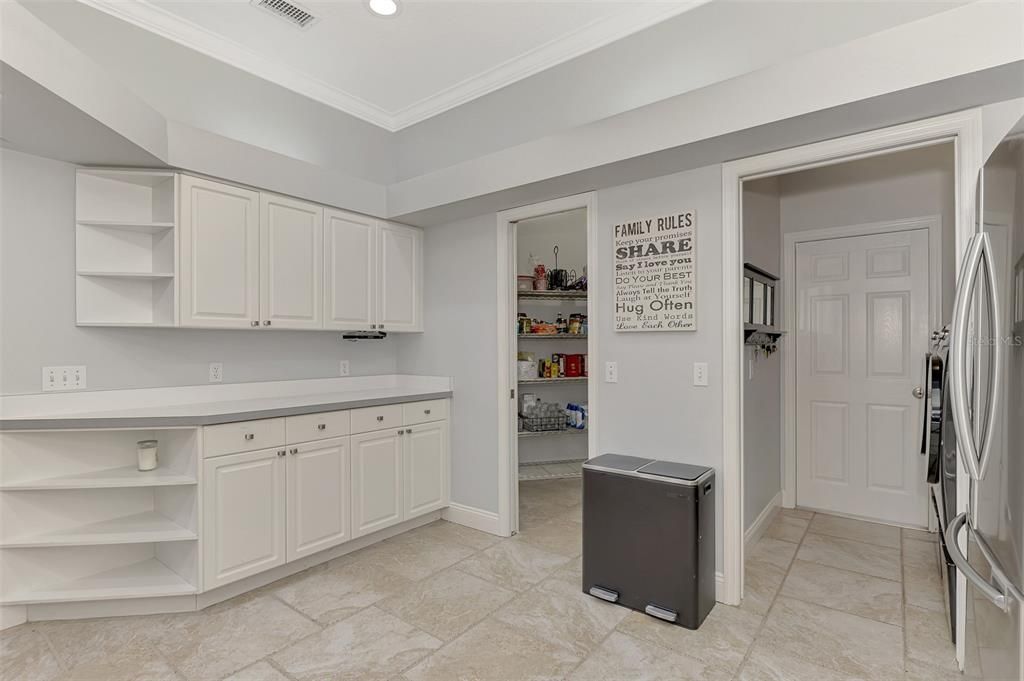 More cabinet and countertop space. The left door is the walk-in pantry.