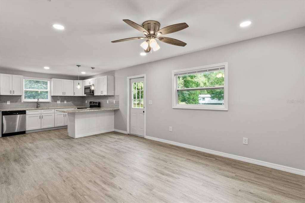 Living/Dining Room Combo...Freshly Painted Interior w/ NEW Ceiling Fans, Blinds & Luxury Vinyl Planking Thoroughout