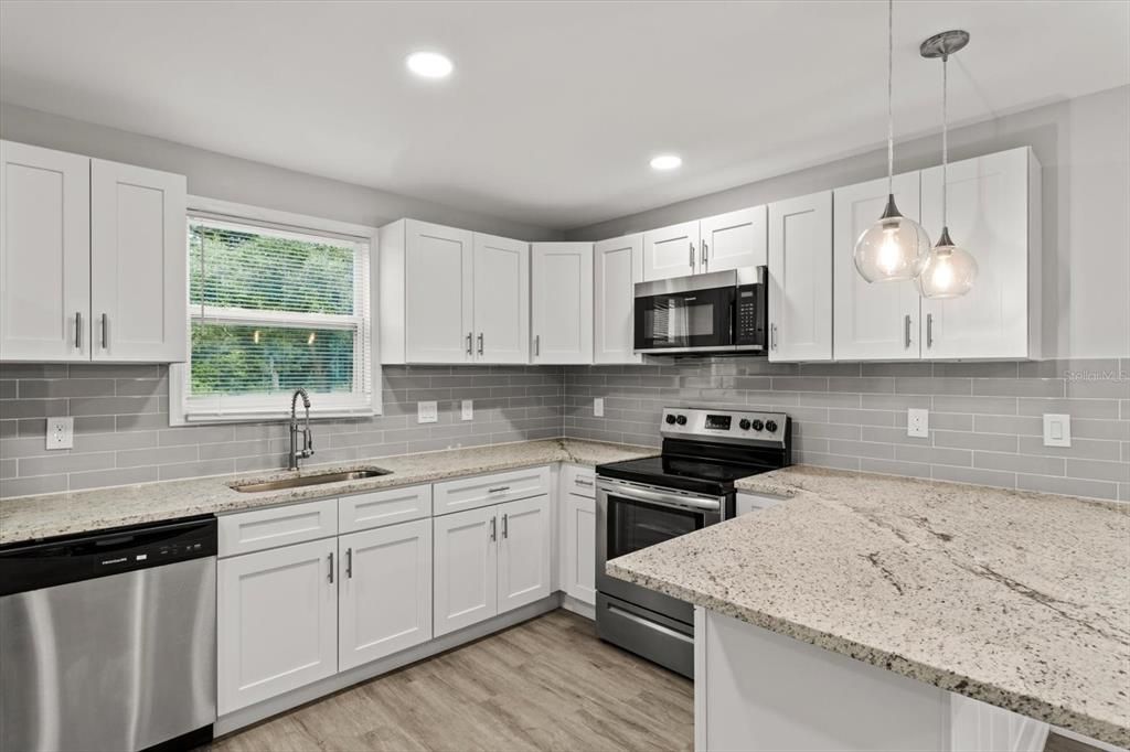 NEW Kitchen w/ NEW White Shaker Cabinets, NEW Granite Countertops, NEW Tile Backsplash, NEW Recessed Lighting & Newer Stainless Steel Appliances