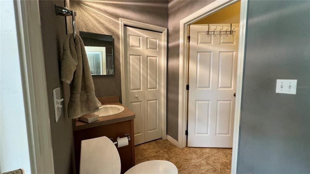 Hallway Bath with Entrance to Pool Entertainment Area