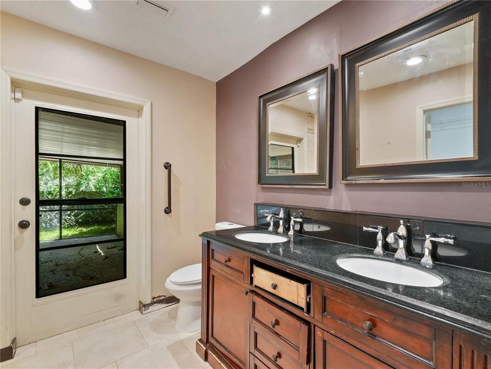 Primary bathroom with door that leads to lanai