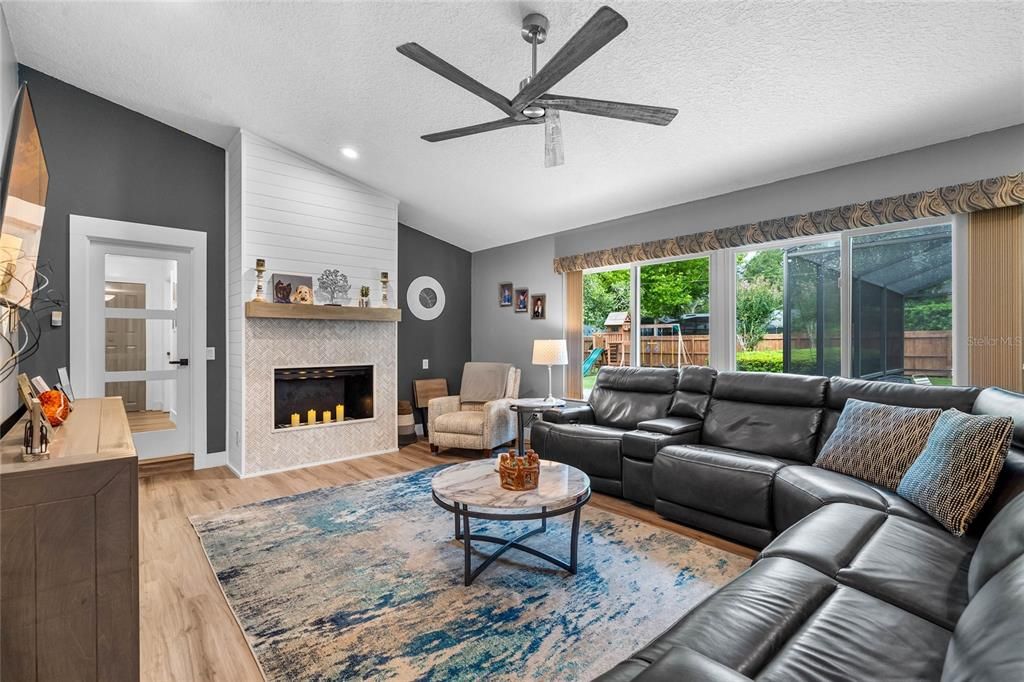 Spacious family room/living room with wood-burning fireplace with on-trend tile design