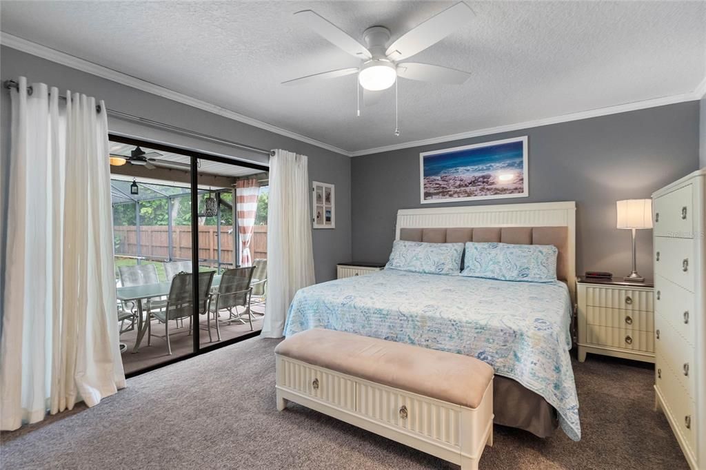 Primary bedroom with sliders out to the pool and Lanai