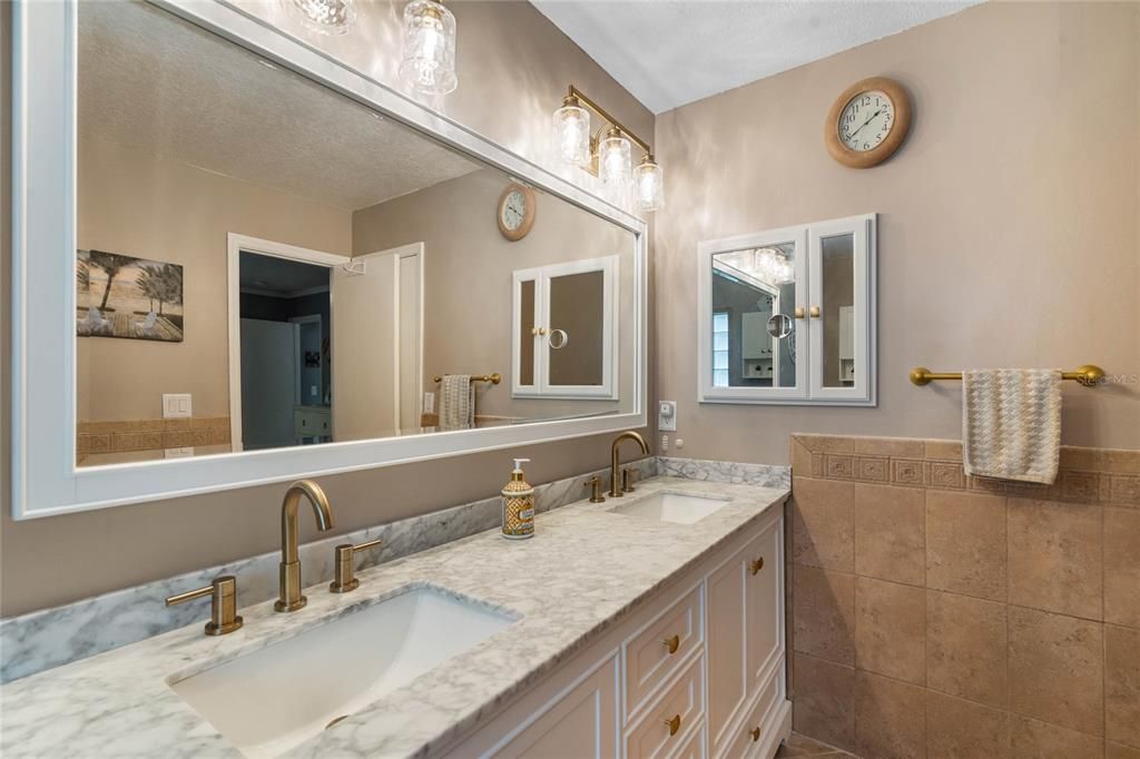 Primary bath has a beautiful vanity with double sinks